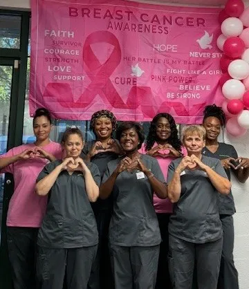 merry maids team members celebrating breast cancer awareness month